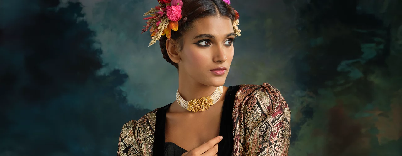 Close-up of woman in Lush Gold jewellery, showcasing intricate gold choker