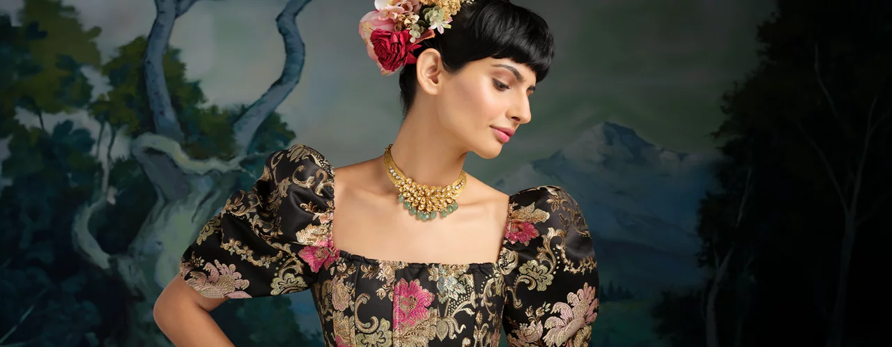 Woman in Lush Gold jewellery, featuring detailed gold necklace