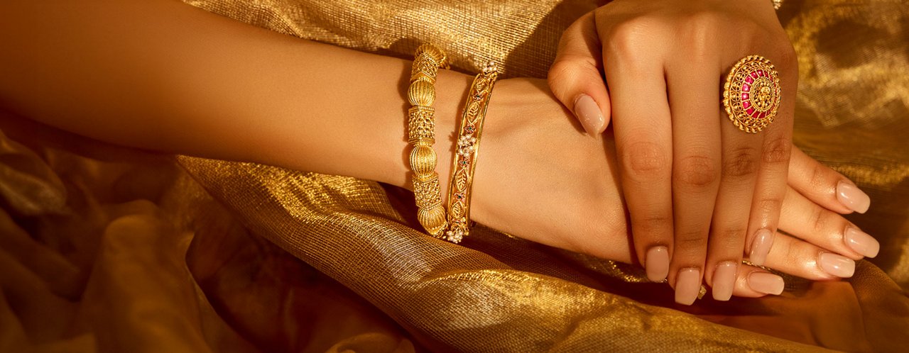 Elegant Hands Wearing Intricate Gold Bangles