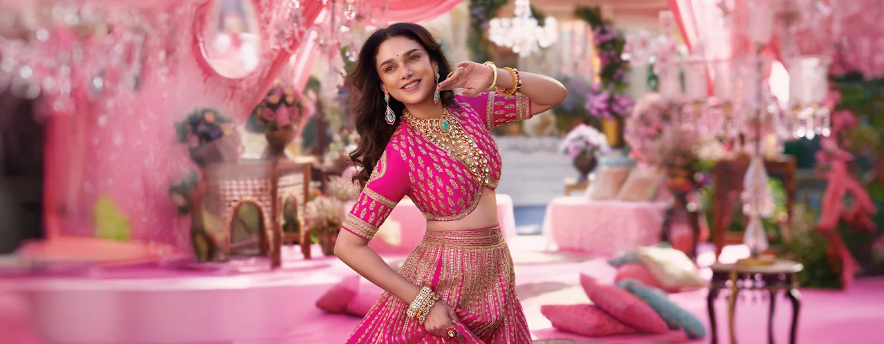 Bride in yellow outfit with green and gold jewellery