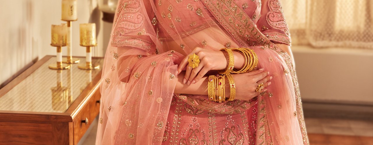 Women Showcasing Her Hands Adorned With Gold Bangles 