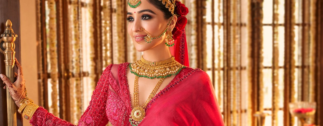 Gold necklace, maang tikka, and bangles with intricate detailing