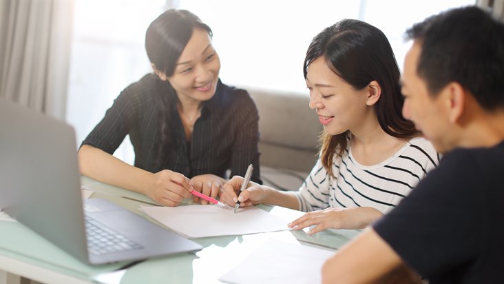 Young business couple signing a contract