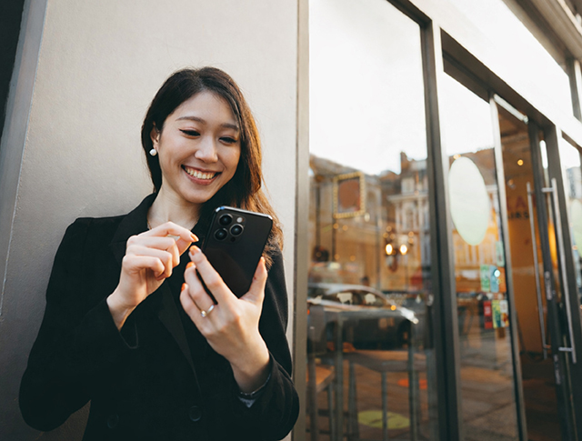 woman using mobile happily