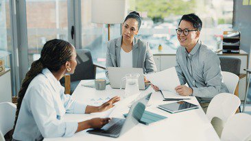 A group of employees discussing plans together
