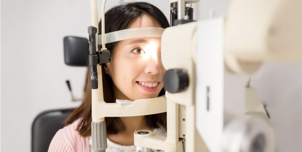 Young woman undergoing an eye examination with a diagnostic device