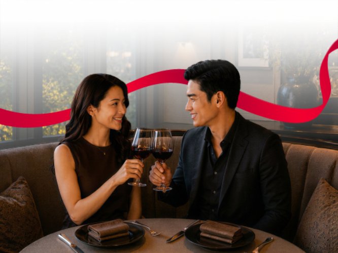Couple toasting with wine glasses over dinner