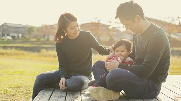 a family of three sititng together