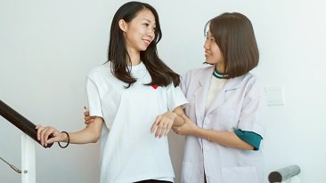 A nurse helping patient