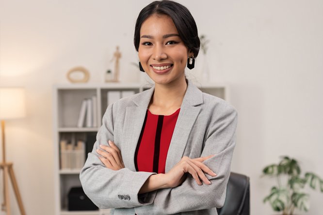 A successful woman standing with her arms crossed.