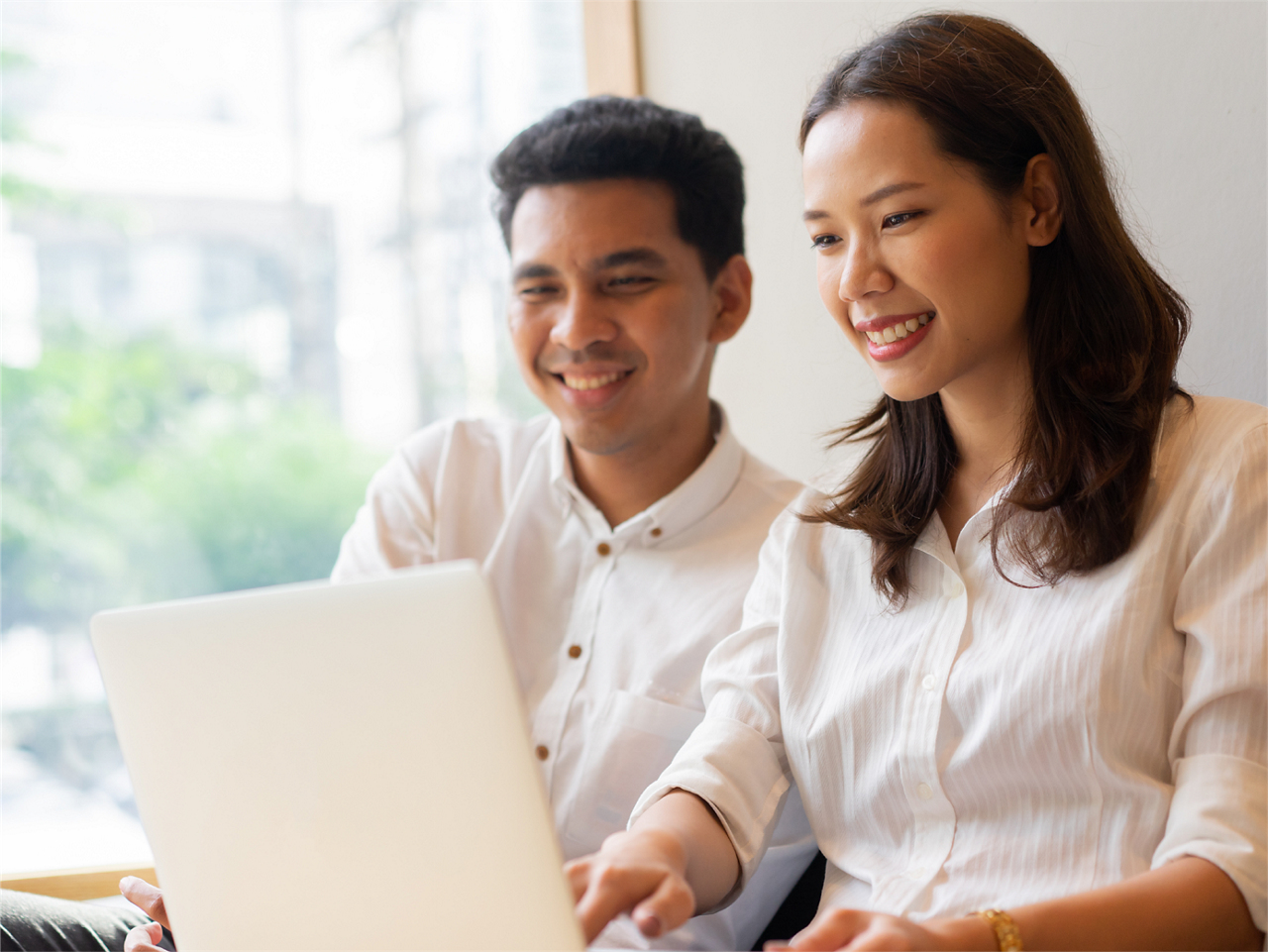 A couple looking at the laptop together