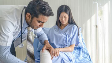 doctor-checking-patient-leg