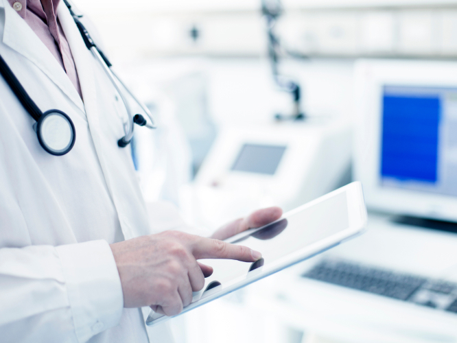 Doctor browsing tablet