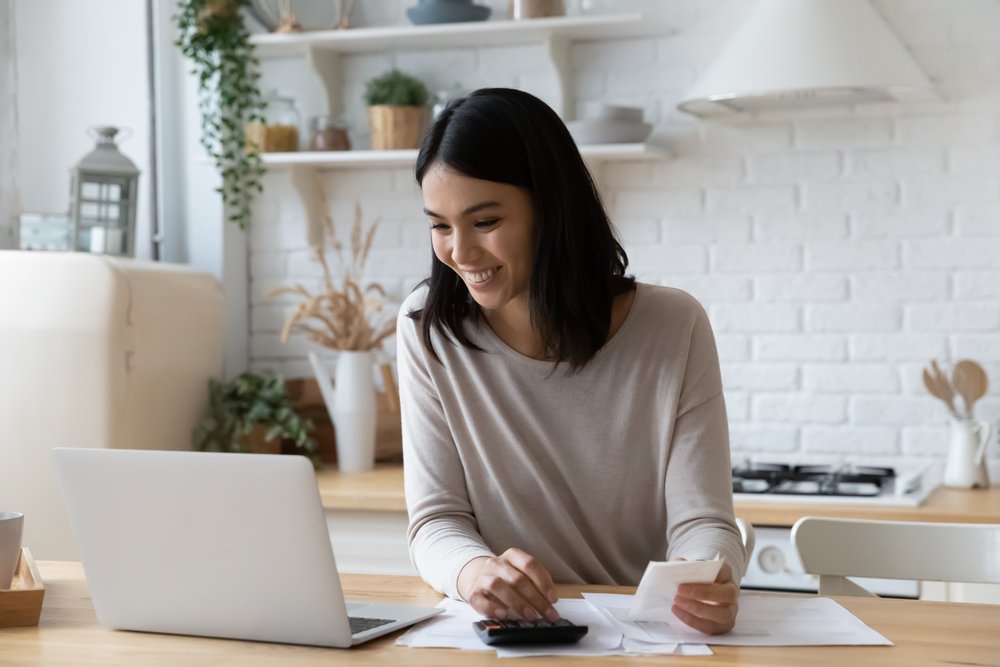 woman calculating with happy facial