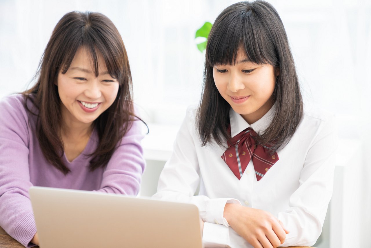 asian parent and daughter,laptop computer,student uniform