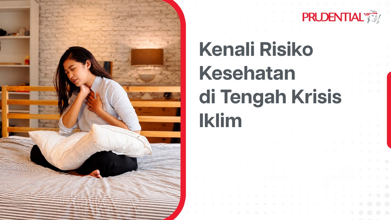A young woman sits on a bed holding her chest, appearing to experience discomfort while clutching a white pillow. The bedroom setting includes a wooden bed frame, striped bedding, and a lit wall lamp against a textured wall. On the right side, Indonesian text reads "Kenali Risiko Kesehatan di Tengah Krisis Iklim" alongside the Prudential name and icon. The overall layout combines a lifestyle photo with an informational health and climate crisis message.
