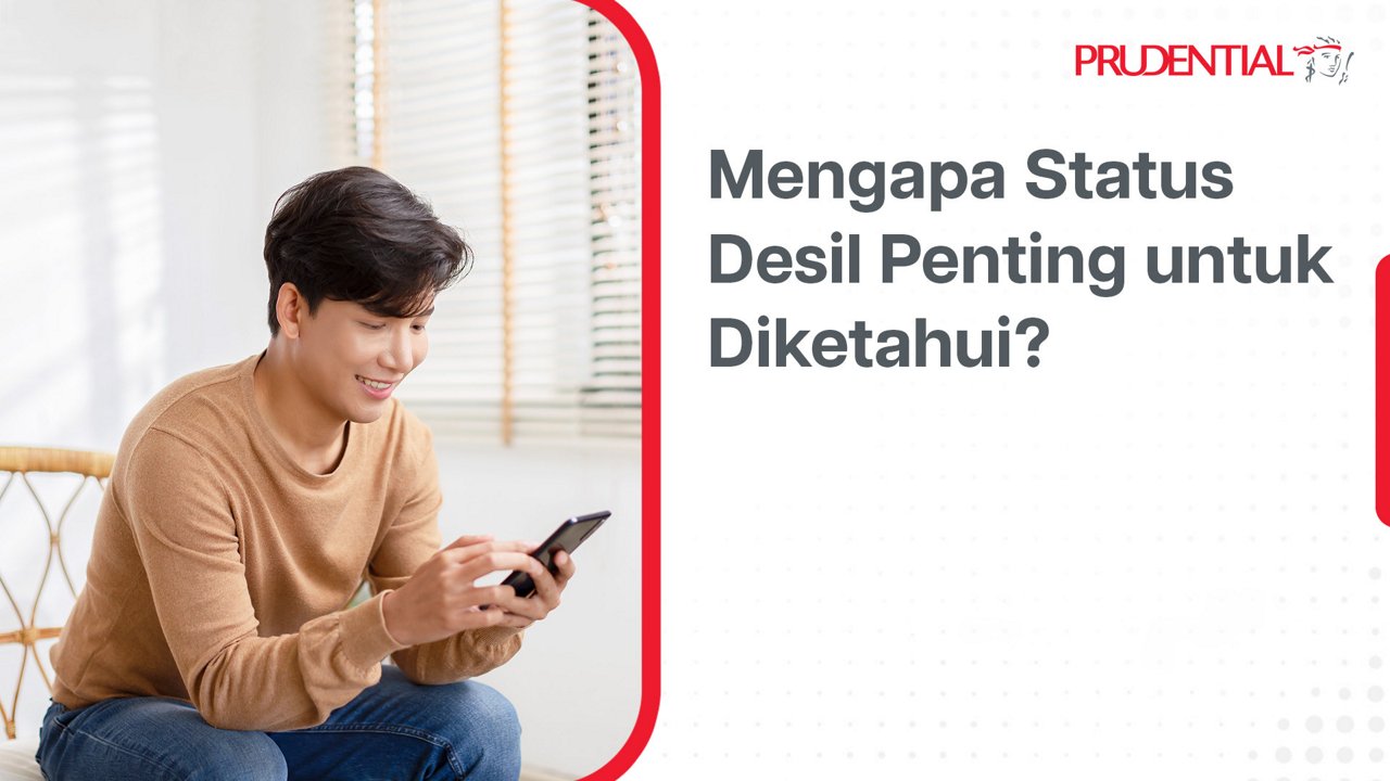 A young man sits indoors on a sofa, smiling while looking at his smartphone. The setting appears bright and casual, with window blinds and soft natural light in the background. On the right side, Indonesian text reads "Mengapa Status Desil Penting untuk Diketahui?" alongside the Prudential name and icon. The overall layout resembles a digital banner or informational social media post.