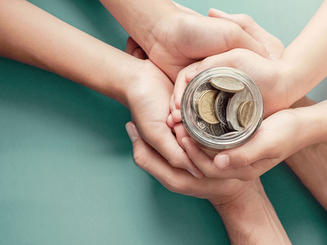 People holding a saving jar