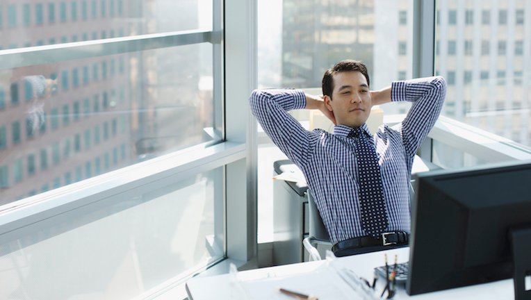Businessman relaxing at desk in office