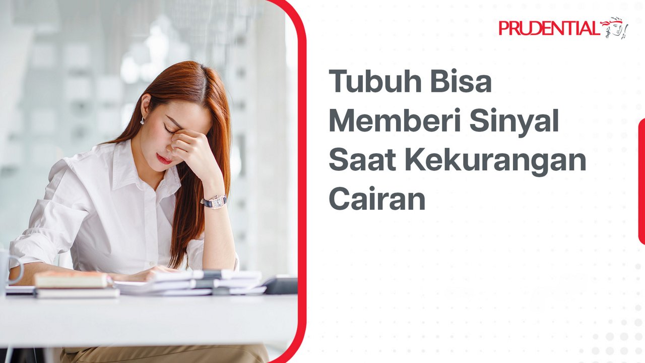 A young woman sits at a desk in an office, resting her head in her hand with a stressed or fatigued expression. Papers, a notebook, and a glass are visible on the table, suggesting a work environment. On the right side, Indonesian text reads "Tubuh Bisa Memberi Sinyal Saat Kekurangan Cairan," highlighting a health message about dehydration. The Prudential name appears at the top right, indicating the source of the informational visual.