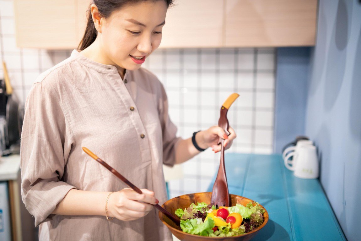 A woman making salad