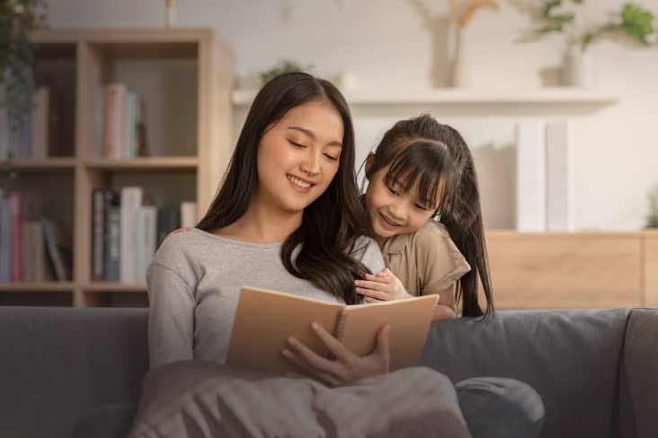 mom and daugther reading a book