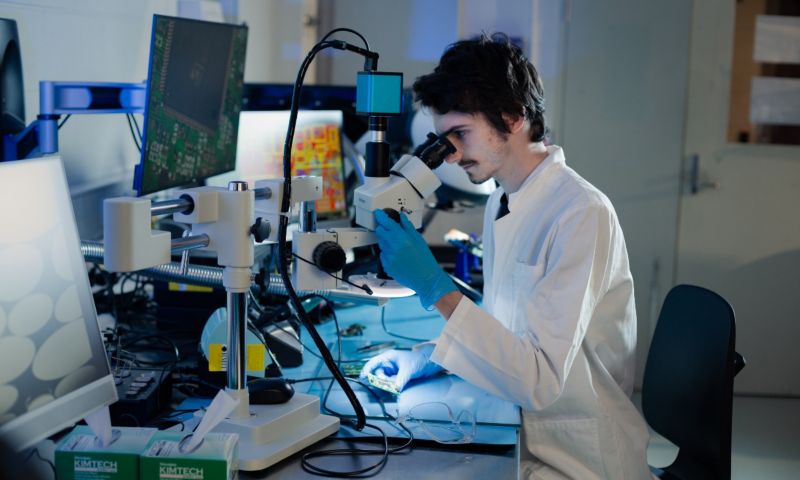 Student looking through microscope in a lab