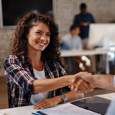 Woman shaking hand over business agreement.