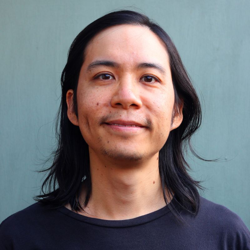 Profile photo of Alan Nguyen smiling towards the camera against a solid blue background