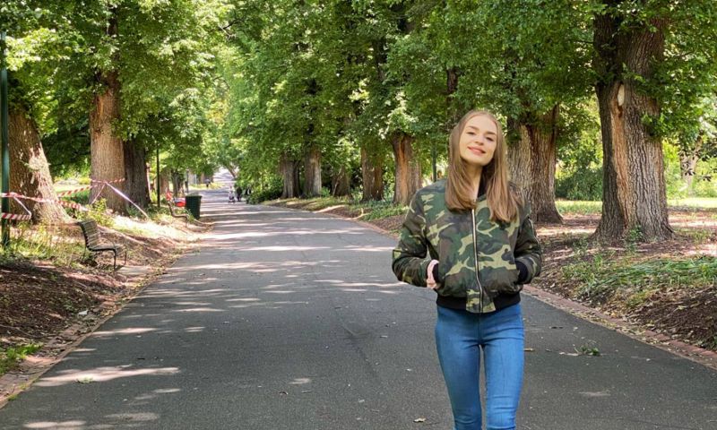 Alicia Currie walking down a path in a park.