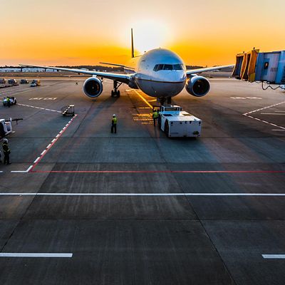 A airplane with a group of workers in a airport