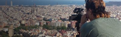 Student filming the city of Barcelona from above