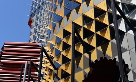 Building 80 exterior with yellow and grey triangles