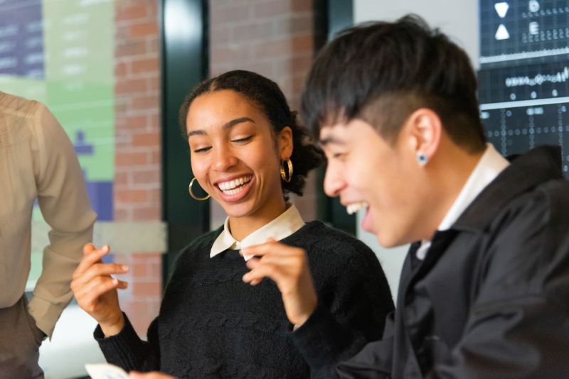 A mentor and an RMIT alumnus sit together with a laptop in discussion