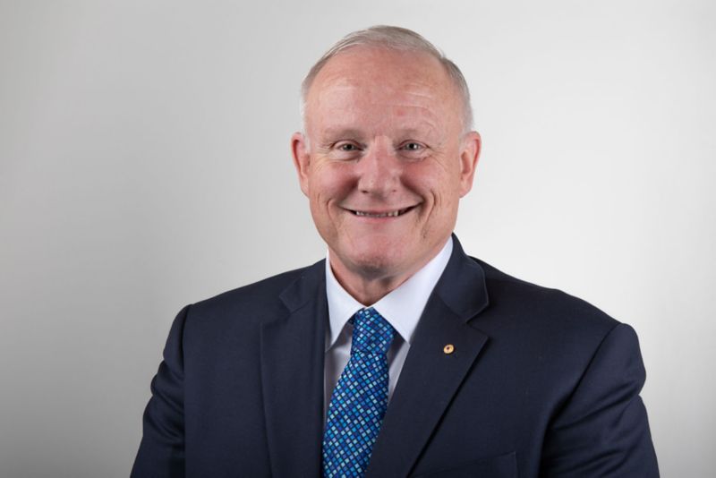 Calum Drummond looking forward and smiling against a solid white background