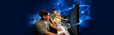 Students working on computers in a Computer Science learning environment with digital technology visualisations in the background