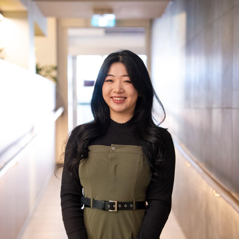 A portrait photograph of Cecilia smiling and looking directly at the camera.