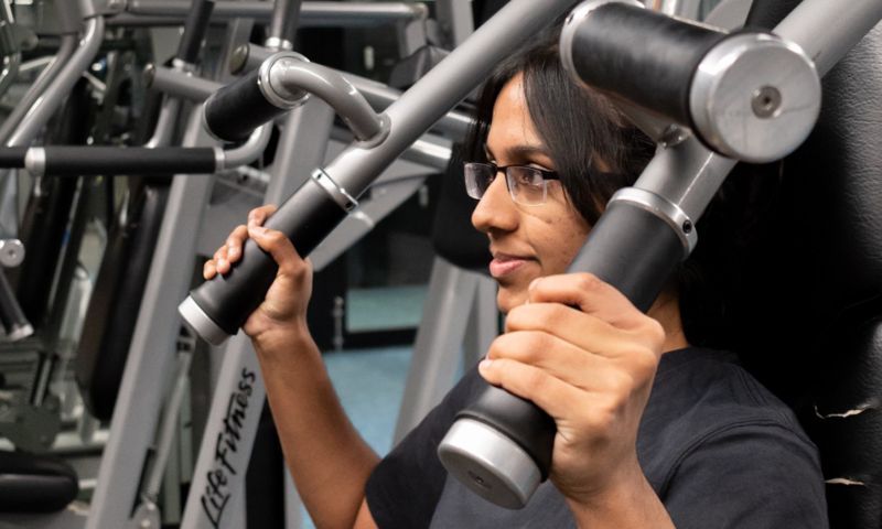 Student using an exercise machine at the Active Hub