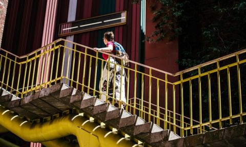 A student climbs the stairs at the City Campus.