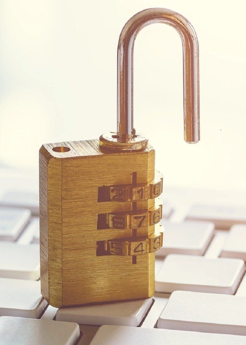 Open padlock sitting on a computer keyboard