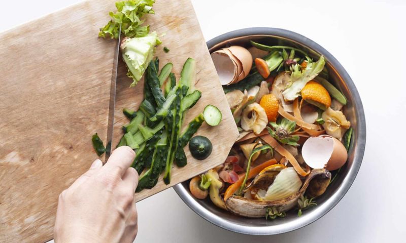 Food waste in iron bowl and cutting board