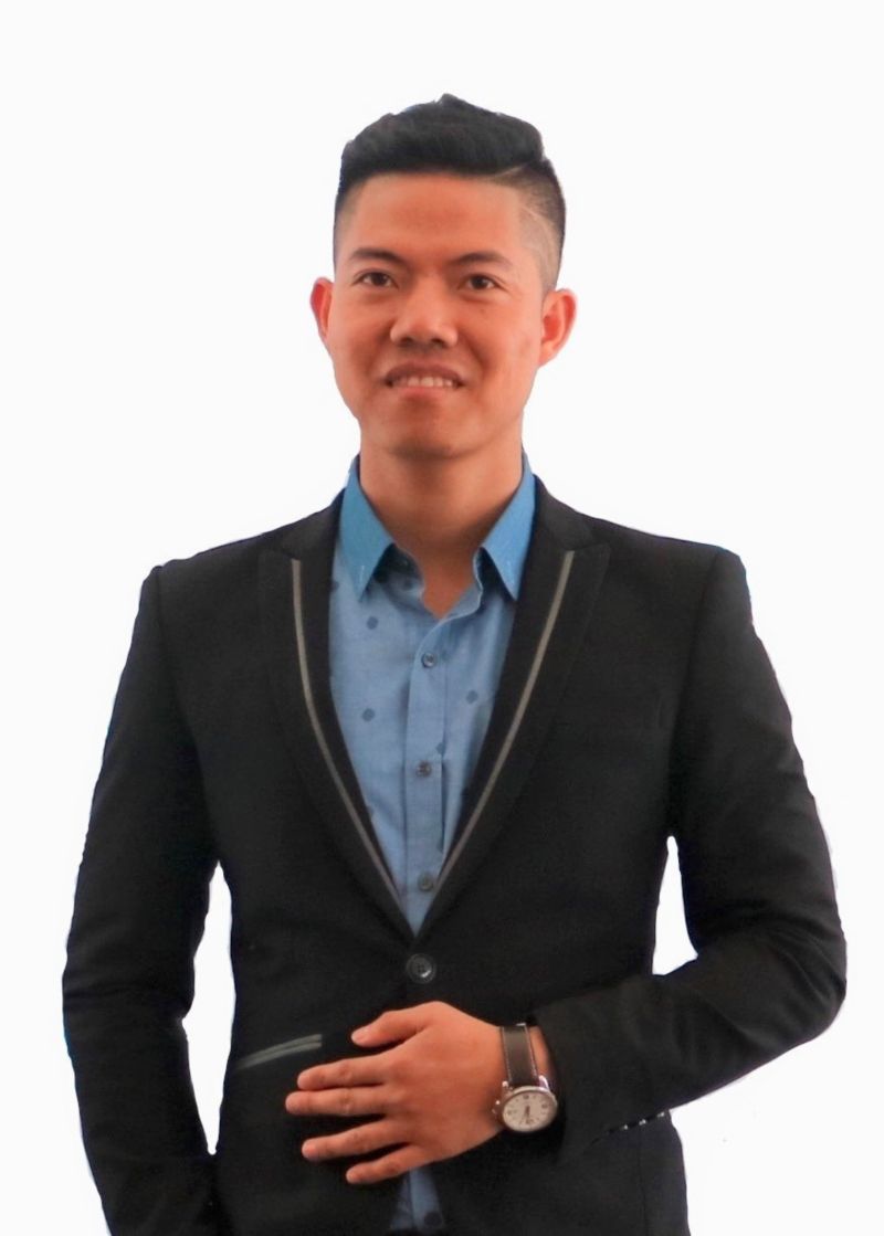 a headshot of an asian man in suit smiling 