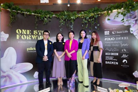 group-of-people-dressed-in-formal-and-colourful-attire-posing-on-stage.jpg