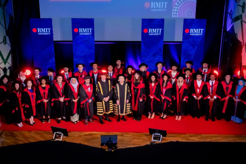 Group of doctoral graduates on stage