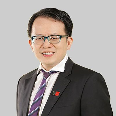 a headshot of an asian man in suit smiling 