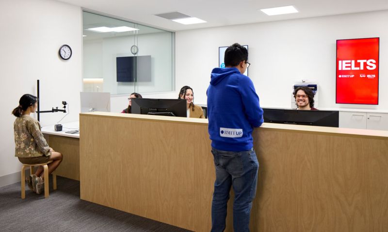 Person standing at IELTS desk