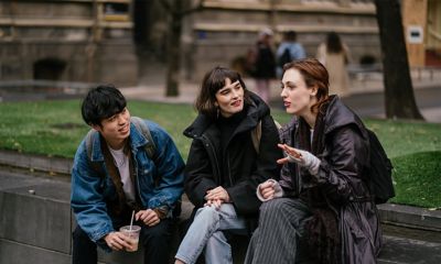 RMIT students sit in discussion on campus, in front of Building 1