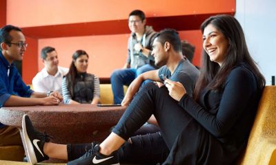 Six international students discussing a topic in a classroom