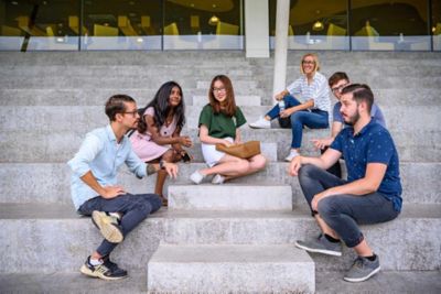 international-students-sitting-chatting-white-stairs-03.jpg