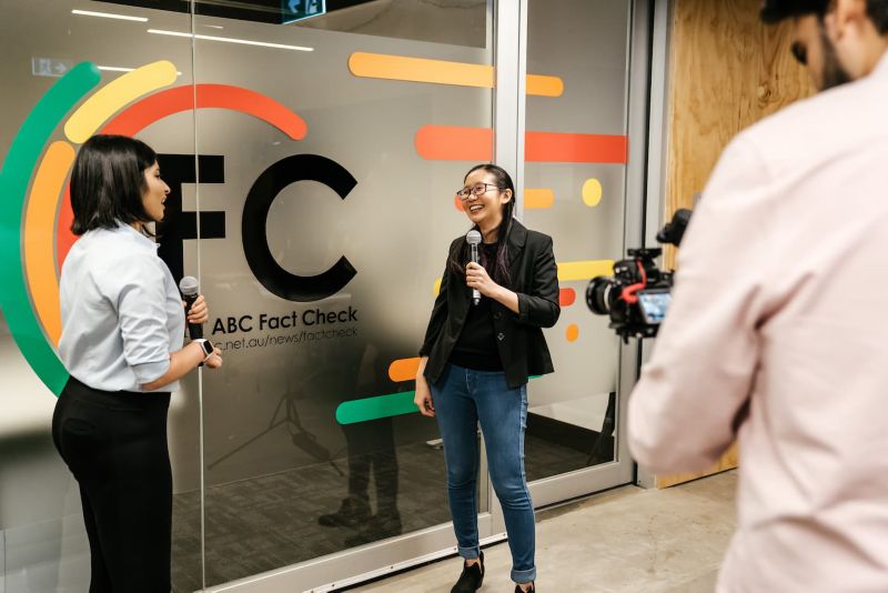 Students film outside RMIT ABC Fact Check Studio